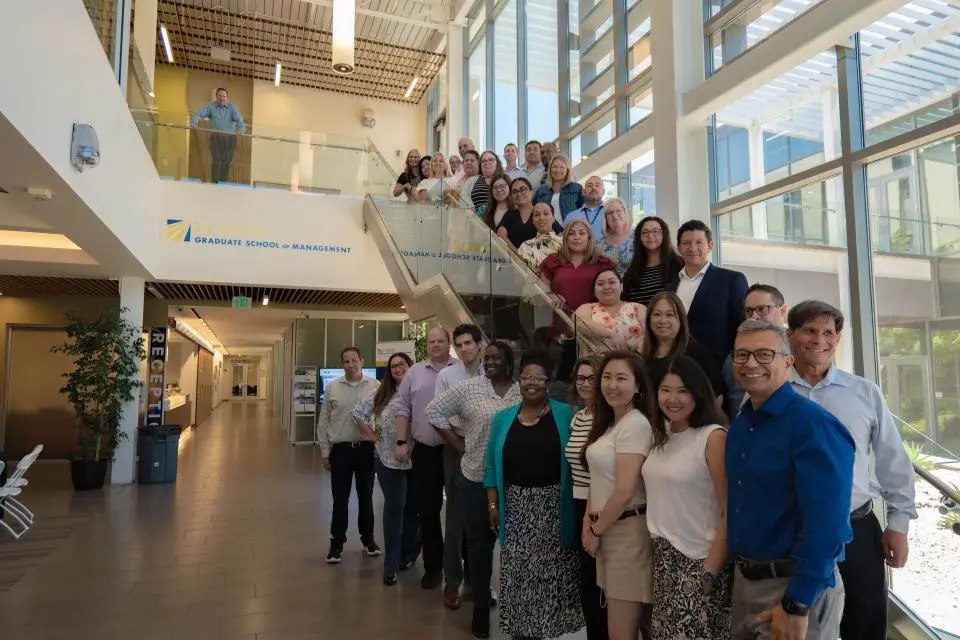 Leadership Academy 2024 participants take a group photo on a staircase