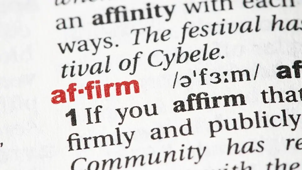 A close-up of a dictionary page showing the word "affirm" in bold red text, with its pronunciation and definition visible.