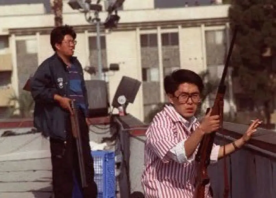 Korean American store owners protecting their stores from their rooftops with rifles during the 1992 Rodney King riots in Los Angeles