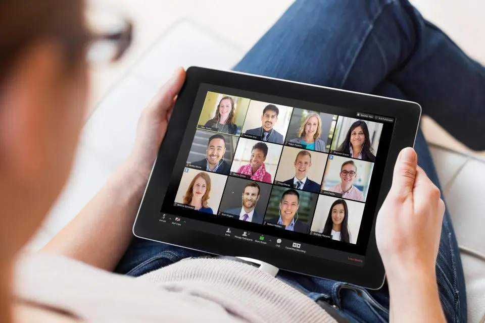 A person in a conference call using a tablet