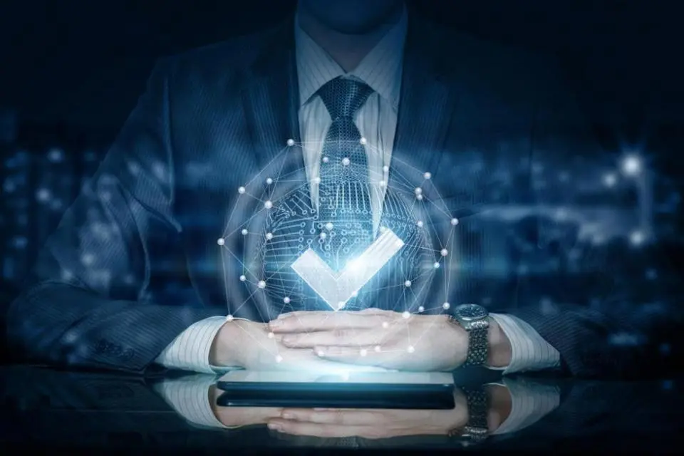 Man resting hands on a tablet with a hologram