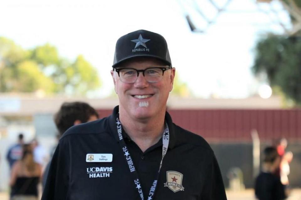 Portrait of Tim Stallings in a black hat and polo shirt