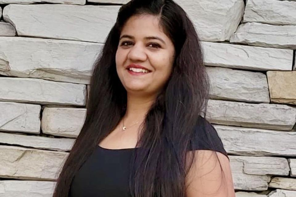 Woman smiling in front of building