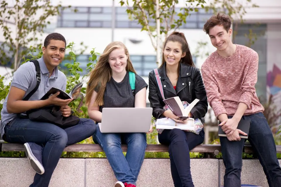 college students sitting on a bench