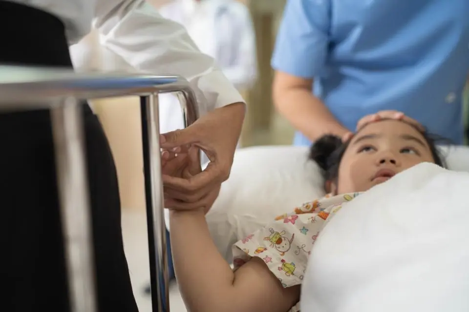 girl laying in hospital gurney