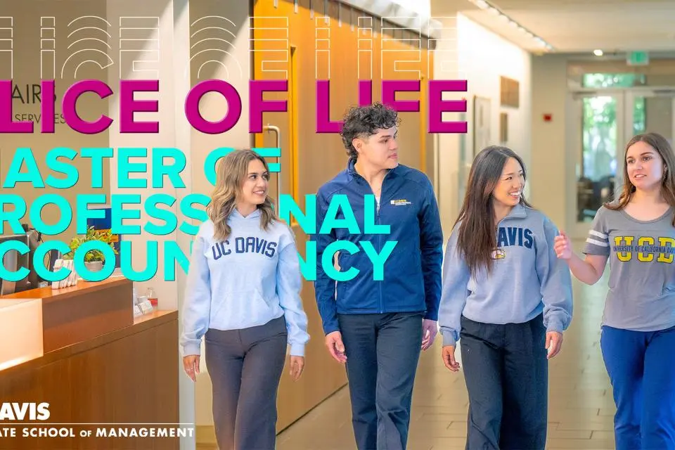 Four students wearing UC Davis sweaters in Gallagher Hall