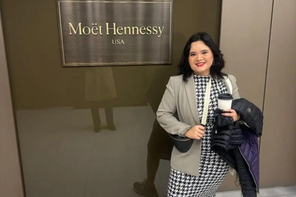 Marisol Ibarra standing in front of Moet Hennessay