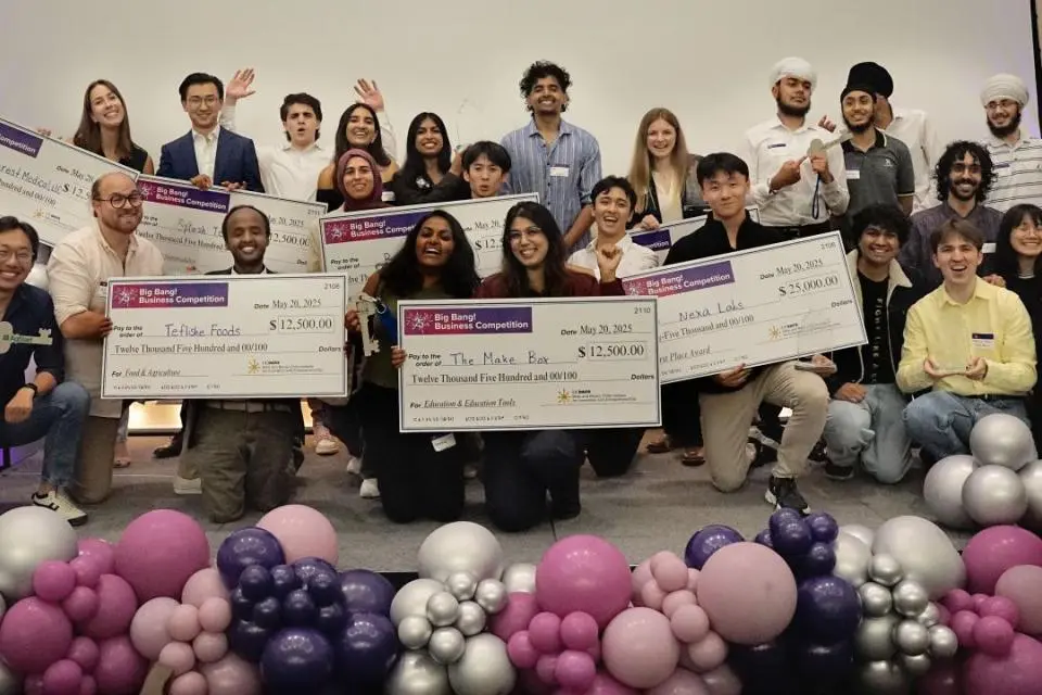 winners on stage with checks