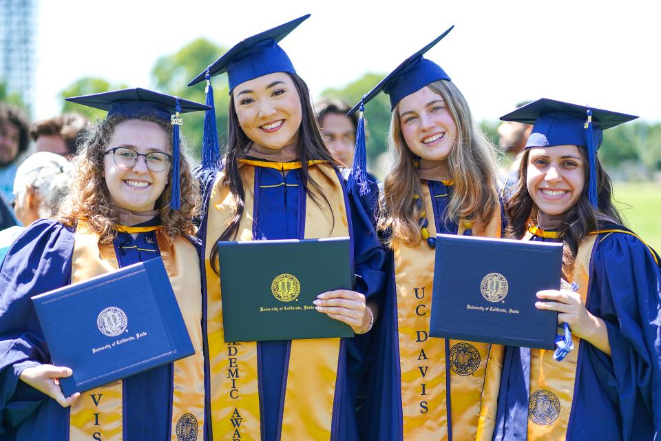 Four graduates at the GSM 2025 commencement ceremony