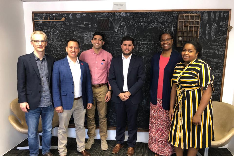group of people in front of chalkboard