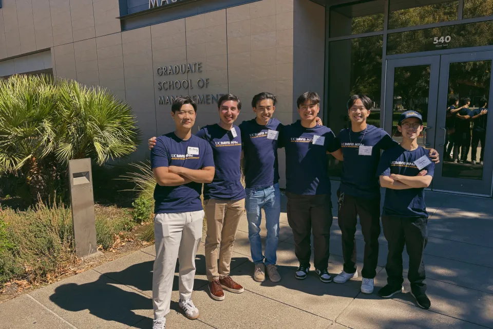 Chris Ngan and other MPAc students stand in front of Gallagher Hall