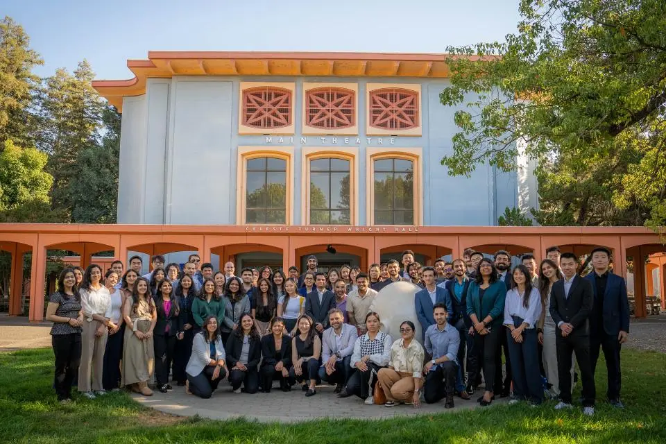 New 2025 MSBA students pose for a group photo in front of a theater on the UC Davis campus