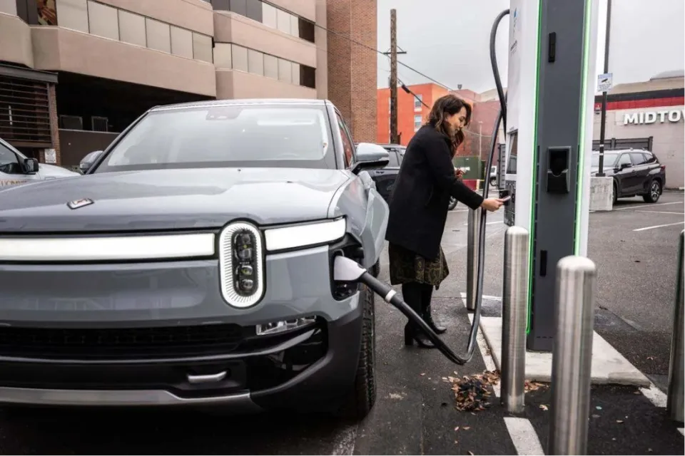 Woman charging EV at charger