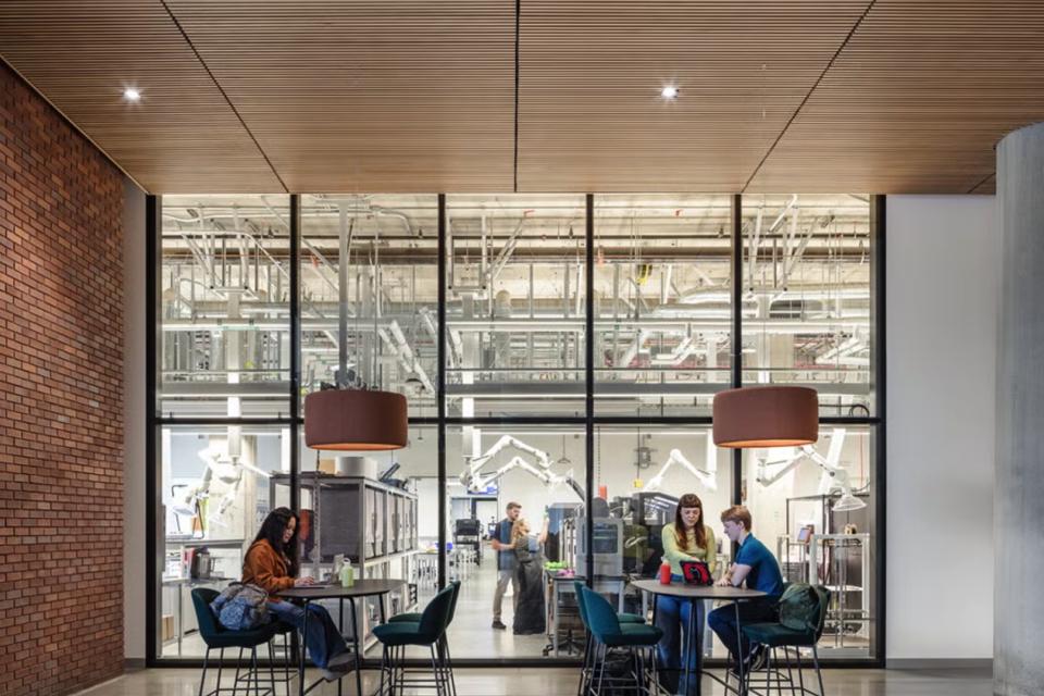 People sit outside of the Tech Foundry, a makerspace at Aggie Square that designs and manufactures devices to support research and solve problems.
