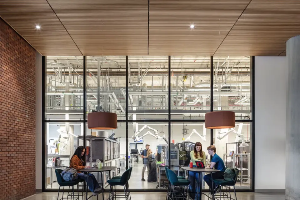 People sit outside of the Tech Foundry, a makerspace at Aggie Square that designs and manufactures devices to support research and solve problems.
