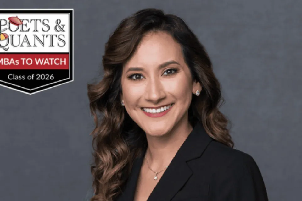 A woman in a black blazer smiles at the camera. Next to her is a “Poets & Quants MBAs to Watch Class of 2026” badge on a gray background.