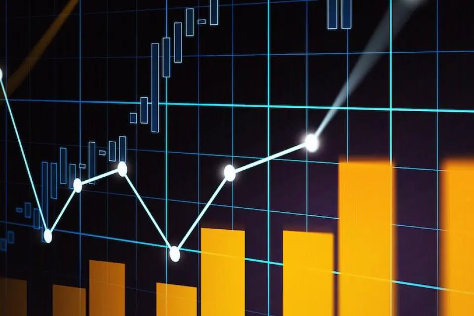 A digital graph showing orange bar charts and a white line graph against a dark grid background, representing financial or data analysis trends.